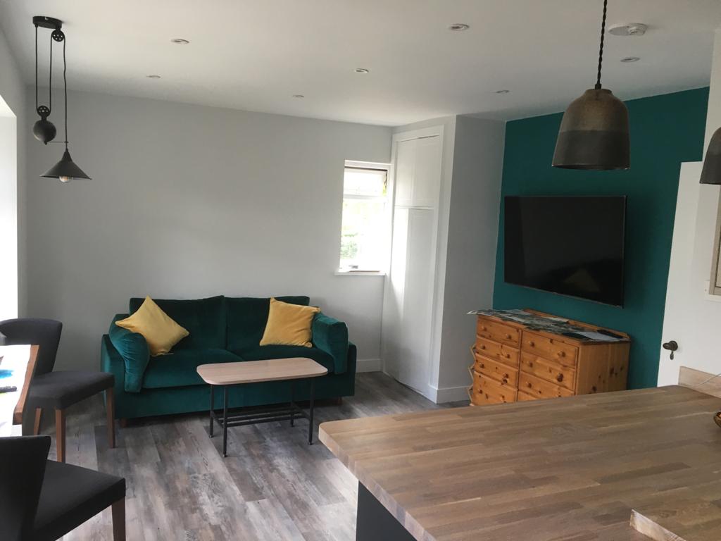 lounge with green wall and sofa